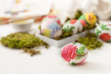 Decoupage on white eggs. The decoration of eggs for Easter.