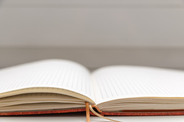 Open blank notepad on white background close-up