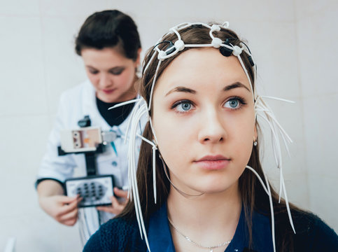 Doctor and patient with encephalography electrode.