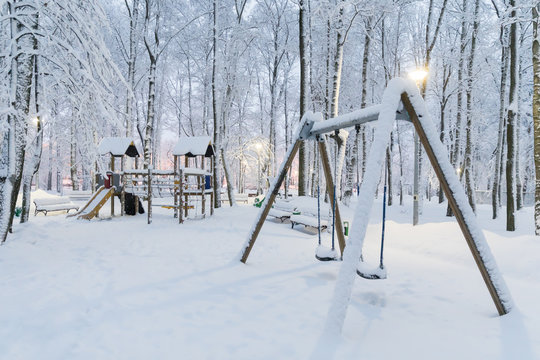 Heavy snowfall in Moscow, children's playground under the snow. Collapse of public services