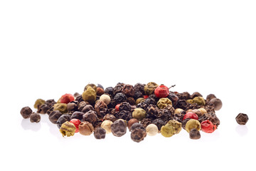 Top view on black, red and white peppercorns isolated on white background, shallow depth of field.