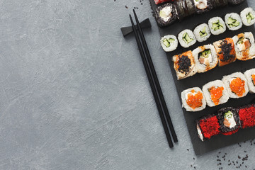 Set of sushi maki and rolls on grey background