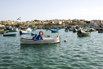 Fototapeta premium Marine with multi-colored painted boats against background of low lodges