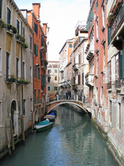 Fototapeta na wymiar Venice. Cozy narrow street. Windows with shutters. Balconies. A charming romantic setting.