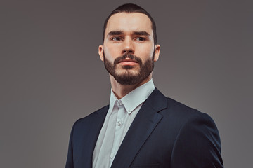 Studio portrait of a brutal bearded businessman wearing a formal