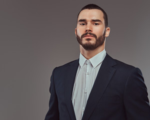 Studio portrait of a brutal bearded businessman wearing a formal