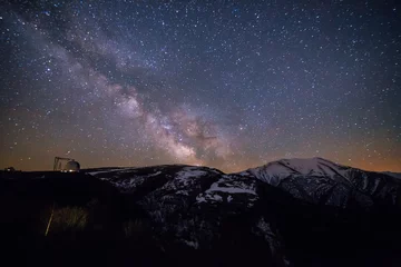 Foto op Canvas Starry sky with milky way over Caucasian mountains and observatory © Mulderphoto