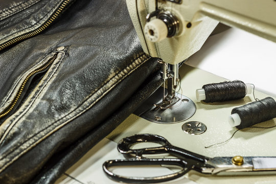 Sewing Leather Jacket Repairing Leather Jacket Scissors, Thread, Sewing Machine, Close-up.