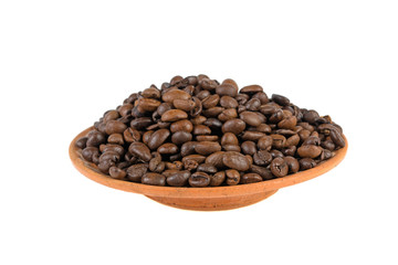 grains of coffee on a clay plate on a white background