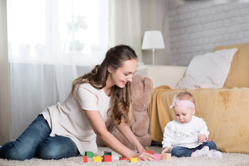 young mother plays with a baby.