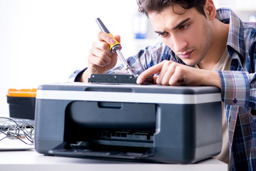 Hardware repairman repairing broken printer fax machine