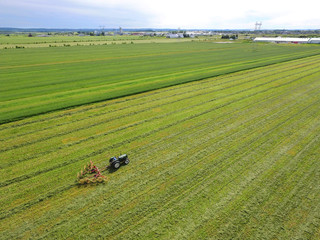 Aerial of tractor with harrow in field - 195901149