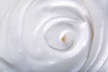 Fototapeta na wymiar close up of a white whipped or sour cream on white background