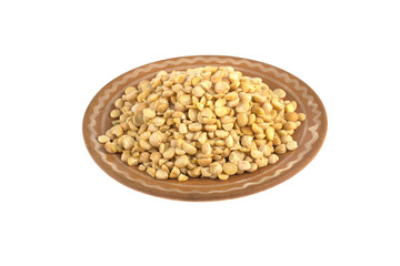 peas on a clay plate on a white background