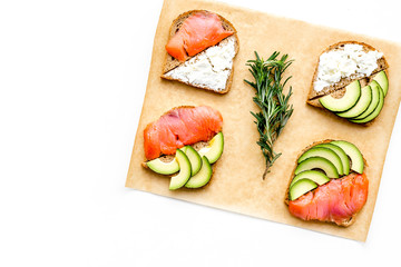 Mini sandwich set with french baguette, cheese, fish and avocado on white background top view mock up