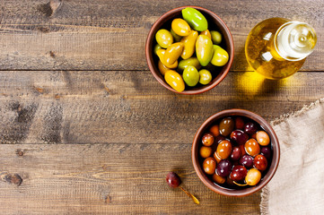 Background with salted olives of several varieties and olive oil