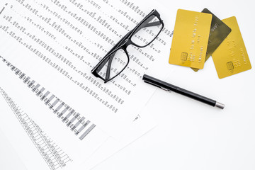 Bank cards for business. Pay bills by card. Bank cards near documents and glasses on white background top view copy space
