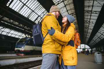 Fototapeta premium happy couple at railway station. meet after long time no see eac