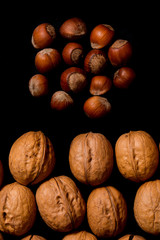 Whole walnuts and cleared on old black metal background, top view. Space for text