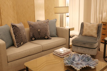 living room with sofa with pillow, armchair and table in the luxury apartment of the hotel