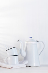 White background with vintage kettle and cups on the wooden table