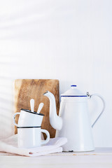 Fototapeta na wymiar White background with vintage kettle and cups on the wooden table