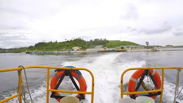 Speedboat under way,  view from the aft ship, leaving the quayside