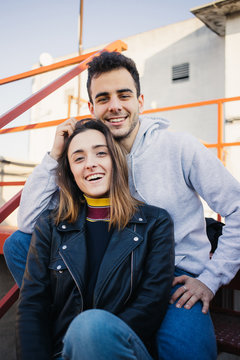 Excited and happy, real life natural image of cute and cool attractive couple, boyfriend and girlfriend from relationship teenager magazine cover laugh and pose for shoot like models on rooftop