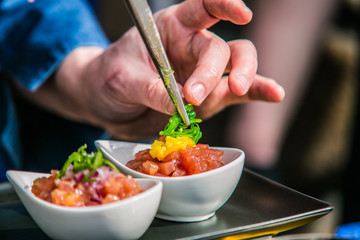 The chef in the kitchen prepares  food. Food detail.  Close-up on the hand of the chef in the kitchen prepares  food