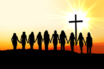 Christian women friendship silhouette walking towards the cross in the light. 