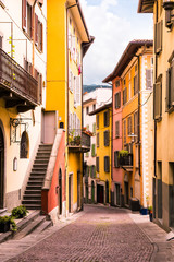 Old scenic street with colorful houses with wooden shutters of the old town. Tourist attraction