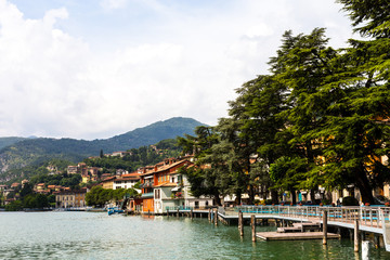 Fototapeta na wymiar Beautiful embankment overlooking the mountains. Lake Iseo, Italy - architecture and travel background.