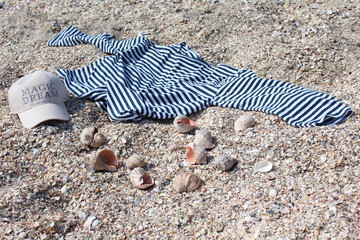 vest shells and cap on the seacoast sand