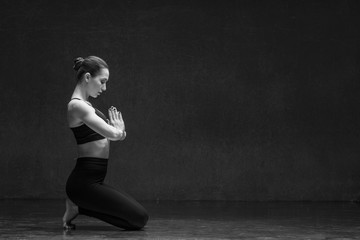 Fototapeta na wymiar Young yoga woman stretching and training in class 
