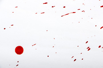 drops of red blood on white paper