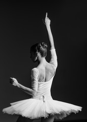 Fototapeta premium Young beautiful ballerina is posing in studio