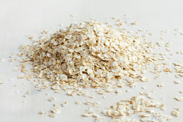 heap of oat flakes on a white background