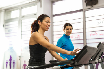 Fototapeta na wymiar Women working on treadmill.