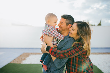 Fototapeta premium happy family mother and father playing with a baby at home