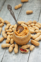 an open jar of peanut butter with spoon