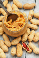 an open jar of peanut butter with spoon