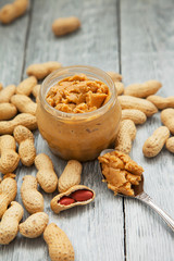 an open jar of peanut butter with spoon