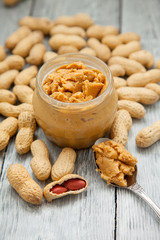 an open jar of peanut butter with spoon