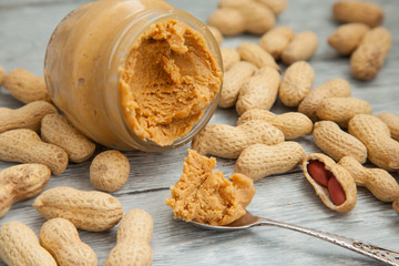 an open jar of peanut butter with spoon