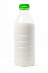 Plastic bottle of milk with a colored cap, white background, iso