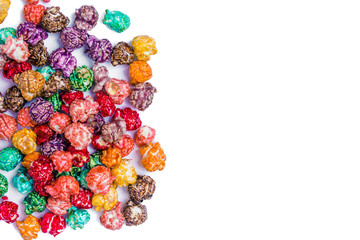 Fototapeta na wymiar Brightly Colored Candied Popcorn, white background. Image of Junk food, fruit flavored popcorn. Colorful, rainbow, candy coated popcorn in old metal cup. Isolated on white selective focus 