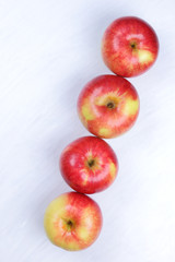 Apples, red apples on a white wooden background, fruits for breakfast, vitamins, vegetarian food, healthy food, American breakfast, lots of apples for designer, copy space, minimalism