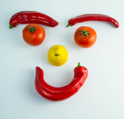 A funny smiling emoticon made of vegetables