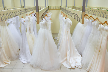 Stylish elegant wedding dress presented on hangers
