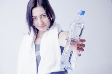 Young beautiful sports girl with water